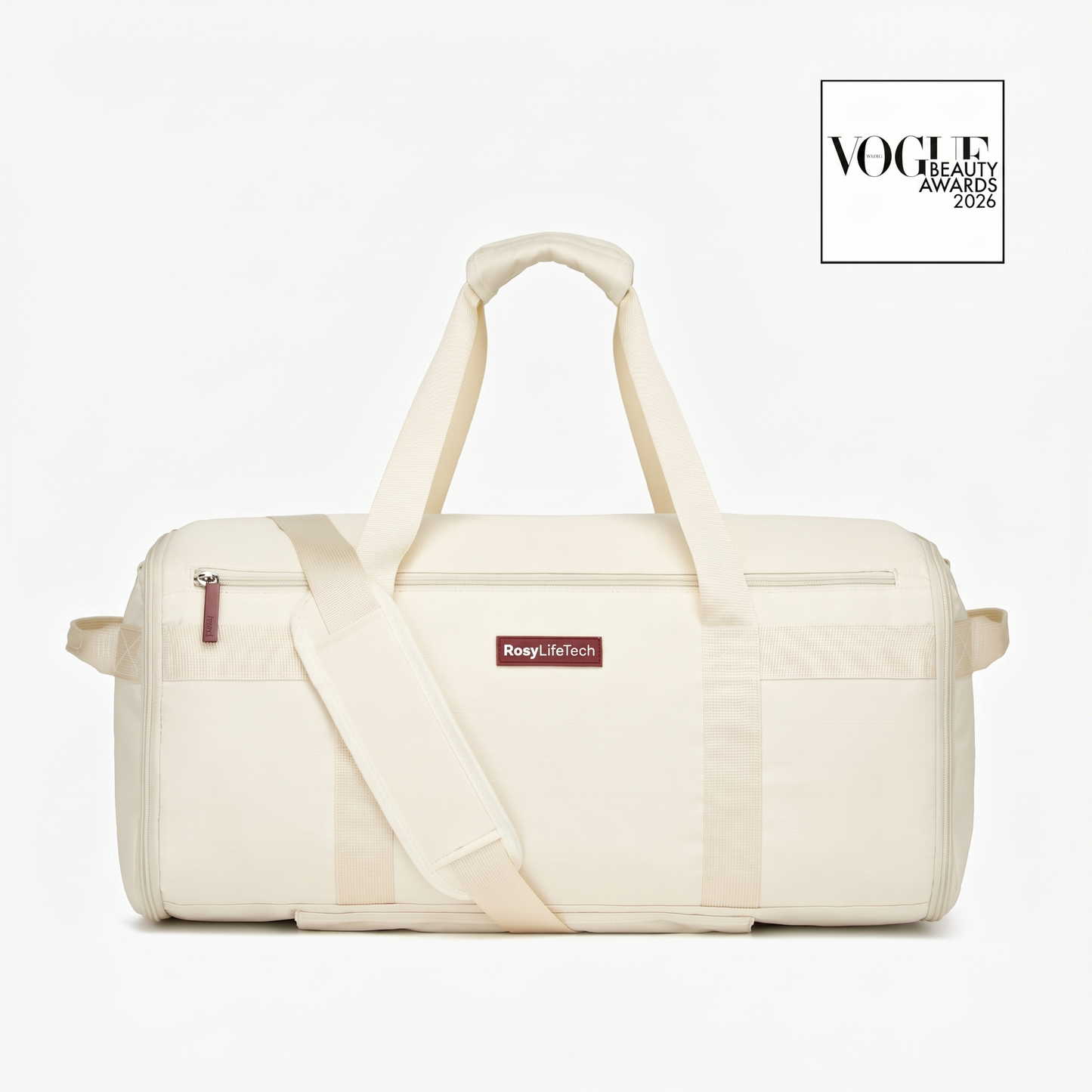 Beige duffel bag with a visible brand label on a white background, featuring the Vogue Beauty Awards logo.