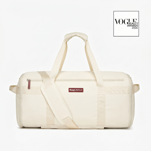 Beige duffel bag with a visible brand label on a white background, featuring the Vogue Beauty Awards logo.