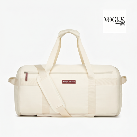 Beige duffel bag with a visible brand label on a white background, featuring the Vogue Beauty Awards logo.